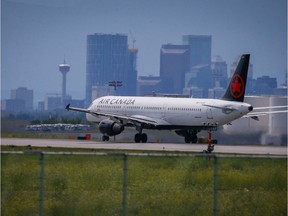 A plane crosses over top of the airport tunnel at YYC Calgary International Airport.