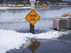 Winter rains atop of snow create a glaze on roads and parking lots and melt Westchester Lagoon, a popular ice-skating and pond-hockey site in Anchorage, Alaska, Dec. 9, 2019.