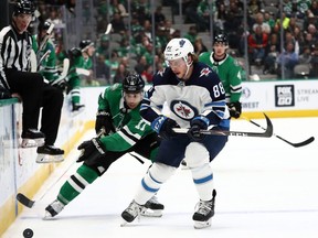 Jets defenceman Nathan Beaulieu (right) missed four games after taking a shot off his hand. (Getty images)