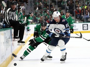 Jets defenceman Nathan Beaulieu (right) missed four games after taking a shot off his hand. (Getty images)