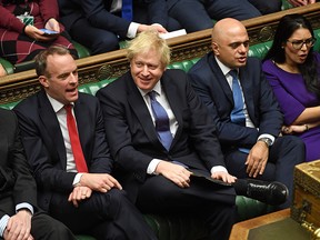 A handout photograph released by the U.K. Parliament shows Britain's Prime Minister Boris Johnson (2nd left) smiling beside (L-R), Britain's Foreign Secretary and First Secretary of State Dominic Raab, Britain's Chancellor of the Exchequer Sajid Javid and Britain's Home Secretary Priti Patel during the Second Reading of the European Union (Withdrawal Agreement) "Brexit" Bill in the House of Commons in London on Dec. 20, 2019.