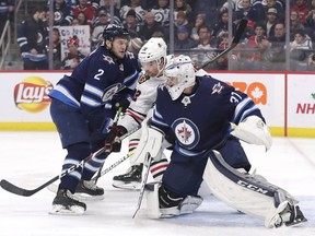 Goaltender Connor Hellebuyck (right) is the biggest reason why the Jets are in the playoff conversation. (USA TODAY)