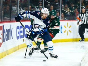 Winnipeg Jets left wing Kyle Connor (81) skates with the puck past Minnesota Wild center Eric Staal (12) in the first period at Xcel Energy Center last month.