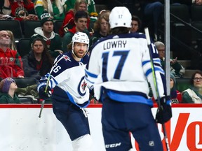 Dec 21, 2019; Saint Paul, Minnesota, USA; Winnipeg Jets right wing Blake Wheeler (26) celebrates with center Adam Lowry (17) after Wheeler scored a shorthanded goal against the Minnesota Wild in the first period at Xcel Energy Center. Mandatory Credit: David Berding-USA TODAY Sports