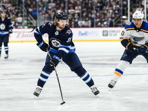 Winnipeg Jets forward Kyle Connor (81) skates with the puck past St. Louis Blues forward Brayden Schenn (10) during the second period at Bell MTS Place in Winnipeg on Dec 27, 2019.