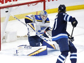 St. Louis Blues goaltender Jordan Binnington saves the shot by Winnipeg Jets' Kyle Connor Friday at Bell MTS Place. (THE CANADIAN PRESS)