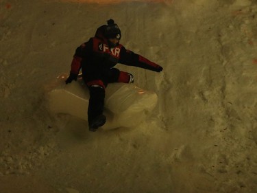Nine-year-old Gerald Dumas, who is from the First Nation community of Pukatawagan, slides down a snow hill during the Illuminate 150 event on the grounds of the Manitoba Legislative Building in Winnipeg, Man., on Saturday, Dec. 14, 2019. The Manitoba 150 host committee kicked off the 150-day countdown to Manitoba Day 2020 by flicking the switch to turn on 300,000 LED Christmas lights on the Manitoba Legislative Building and grounds.