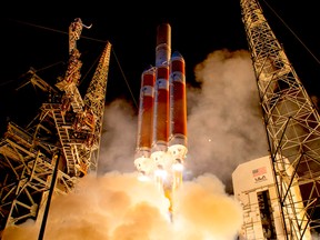 This handout photograph courtesy of NASA shows the United Launch Alliance Delta IV Heavy rocket launching NASA's Parker Solar Probe to touch the Sun, Sunday, Aug. 12, 2018, from Launch Complex 37 at Cape Canaveral Air Force Station, Fla.