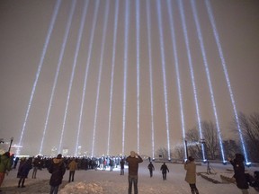 Fourteen lights shine skyward at a vigil honouring the victims of the 1989 Ecole Polytechnique attack, Thursday, December 6, 2018 in Montreal.