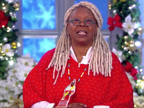 The View host Whoopi Goldberg wears a red jingle dress medallion created by Mish Daniels to spotlight missing and murdered Indigenous women.