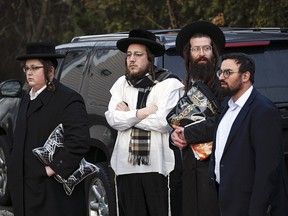 Members of the Jewish community gather outside the home of rabbi Chaim Rottenbergin Monsey, in New York on December 29. (KENA BETANCUR/AFP via Getty Images)