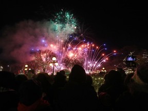 Thousands of Manitobans watch fireworks light up the nigh sky as 300,000 LED Christmas lights are turned on to illuminate the Manitoba Legislative Building and the grounds during the Illuminate 150 event on Saturday.