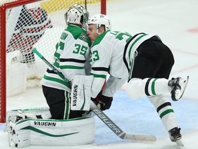 Dallas Stars defenceman Esa Lindell (right) runs into goaltender Anton Khudobin while facing the Jets on Tuesday. Kevin King/Winnipeg Sun/Postmedia Network