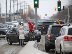 Eastbound traffic on Ellice Avenue at St. James Street was snarled in the afternoon Saturday after a vehicle knocked down a light post and became stuck on the median.
