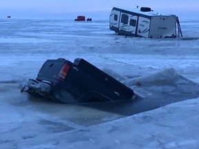 Three trucks and a trailer went through the ice on Lake Winnipeg on Sunday.