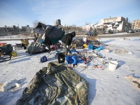 The State of the inner-city report was delivered today in Winnipeg.  A man picks trough rubbish among a cluster of tents near Main Street.   Wednesday, December 11/2019 Winnipeg Sun/Chris Procaylo/stf