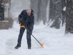 A man clearing snow in front of a church in Osborne Village, in Winnipeg.  Friday, December 13/2019 Winnipeg Sun/Chris Procaylo/stf