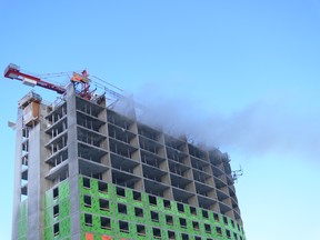 Dark smoke billows from the scene of a two-alarm fire at an apartment complex under construction on Pembina Highway in Winnipeg on Saturday. At 12:31 a.m. Winnipeg Fire Paramedic Service crews responded to reports of a fire in a 15-storey building in the 2500 block of Pembina Highway.