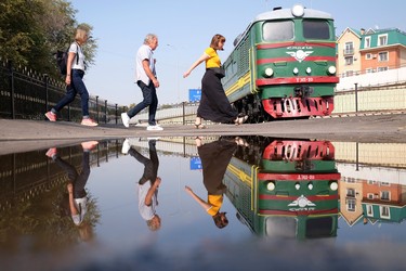 Travellers are reflected in water at a train museum in Tashkent, Uzbekistan, in mid October, 2019.  Saturday, December 28/2019 Winnipeg Sun/Chris Procaylo/stf