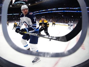 Chris Wagner of the Boston Bruins defends Dmitry Kulikov of the Winnipeg Jets during the first period at TD Garden in Boston. (Photo by Maddie Meyer/Getty Images)