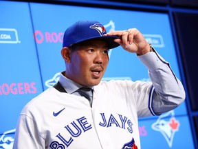 New Toronto Blue Jays signing Shun Yamaguchi adjusts his hat during a news conference on Wednesday. (GETTY IMAGES)