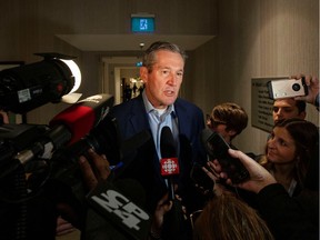 Manitoba Premier Brian Pallister speaks to reporters before Canada's provincial premiers meet in Toronto on Dec. 2, 2019. Manitoba's major political parties all cut their spending in the last election campaign, despite having higher donation and expense limits.