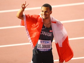 In this Oct. 1, 2019, file photo, Canada's Andre De Grasse celebrates after winning silver in the men's 200 metres final during the 2019 IAAF World Athletics Championships at the Khalifa International Stadium in Doha, Qatar.