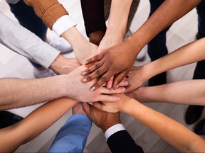 High Angle View Of Multiracial Friend Stacking Hand Together