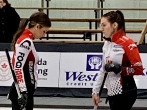 Third Jenna Loder (left) and skip Beth Peterson take a look at a rock they hoped might be biting the rings during a game against Jen Clark-Rouire at the Manitoba Scotties on Thursday. After a measure, it was ruled out and Peterson went on to lose 8-5. (TED WYMAN/WINNIPEG  SUN)