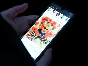 An Iranian woman shows a photo of the late Iranian Major-General Qassem Soleimani, during a protest against the assassination of Soleimani, head of the elite Quds Force, and Iraqi militia commander Abu Mahdi al-Muhandis, who were killed in an air strike at Baghdad airport, in front of UN office in Tehran, Iran Jan. 3, 2020.