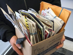 A Winnipeg resident found a large bundle of mail containing more than 100 pieces of mail dating to more than a year ago in a Winnipeg back lane on Thursday, Jan. 2. JOSH ALDRICH/Winnipeg Sun/Postmedia Network