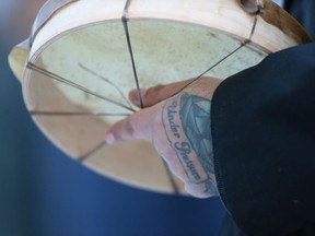 Will Landon holds a drum before singing at a vigil Saturday for Inuk singer-songwriter Kelly Fraser.