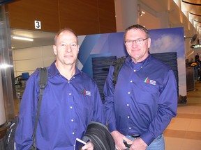 Trevor Tetrault (left) and Geoffrey Smith of the Manitoba Wildfire Program prepare to leave James Richardson International Airport in Winnipeg on Saturday to head to Australia to help combat the raging wildfires.