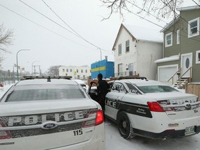 Police gathered outside a home at 516 Alexander Avenue in Winnipeg on Wed., Jan. 15, 2020. Police found a deceased male at the residence on Tuesday and said the circumstances surrounding his death are suspicious. A woman has now been charged with second-degree murder. Kevin King/Winnipeg Sun/Postmedia Network file