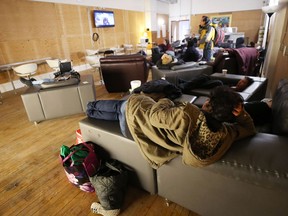 A woman relaxes on a couch inside the Main Street Project warming centre on Main Street in Winnipeg on Sunday.