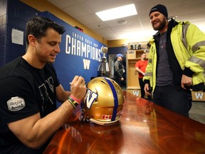 Winnipeg Blue Bombers quarterback Zach Collaros signs a helmet during an autograph session in the team locker room on Tues., Jan. 28, 2020. Kevin King/Winnipeg Sun/Postmedia Network