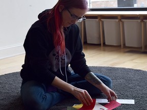 Megan Crane works on putting together Palentine's Day cards to be sent to emerency women's shelters from across North America. Megan Crane/Handout