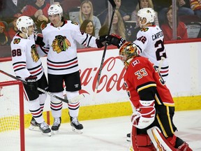 The Chicago Blackhawks celebrate scoring on Calgary Flames goalie David Rittich during NHL action in Calgary on Saturday, February 15, 2020. Gavin Young/Postmedia