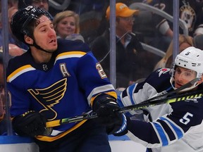 Luca Sbisa  of the Winnipeg Jets checks Alexander Steen of the St. Louis Blues at the Enterprise Center on February 6, 2020 in St. Louis, Missouri.  (Photo by Dilip Vishwanat/Getty Images)