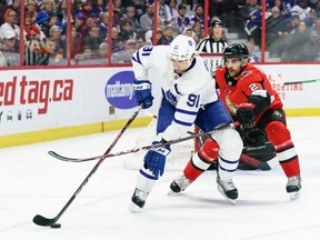 Dylan DeMelo of the Ottawa Senators uses his stick to slow down a puck carrying John Tavares of the Toronto Maple Leafs in the first period at Canadian Tire Centre on Saturday in Ottawa,