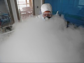 A worker with sanitizing equipment disinfects an office following an outbreak of the coronavirus in the country, in Shanghai, Feb. 12, 2020. (cnsphoto via REUTERS)