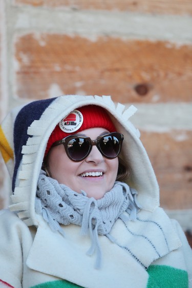 Melanie Lesk watches the reenactment of the Red River Skirmish between La Compagnie de La Vérendrye and the Forces of Lord Selkirk inside Fort Gilbraltar on the final day of the 51st annual Festival du Voyageur in Winnipeg, Man., on Sunday, Feb. 23, 2020. (Brook Jones/Postmedia Network)
