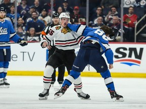 Winnipeg Jets defenceman Nathan Beaulieu (88) fights Chicago Blackhawks defenceman Nick Seeler (55) during the second period at Bell MTS Place. M Terrence Lee-USA TODAY Sports