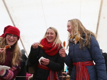 Brooklynne, Chris and Kendra Grieger are all smiles as they enjoy taffy on snow while attending Festival du Voyageur in Winnipeg, Man., on Sunday, Feb. 16, 2020. The 51st annual Festival du Voyageur in Winnipeg, Man., runs from Feb. 14 to 23, 2020.