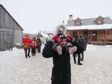Erin Tan carries her two-year-old daughter Eiley on her shoulders while attending Festival du Voyageur on Louis Riel Day in Winnipeg, Man., on Monday, Feb. 17, 2020. The 51st annual Festival du Voyageur in Winnipeg, Man., runs from Feb. 14 to 23, 2020.