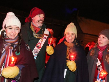 Festival du Voyageur's official family, the Régniers, hold candles as they participate in Torch Light Walk celebrating the opening of Festival du Voyageur in Winnipeg, Man., on Friday, Feb. 14, 2020. The 51st annual Festival du Voyageur runs from Feb. 14 to 23, 2020.