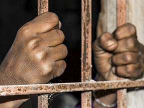 closeup of brown hands of prison inside the jail