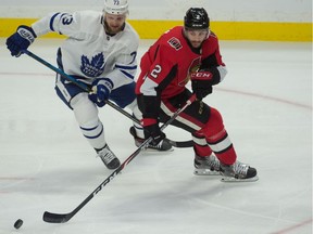 Toronto Maple Leafs left wing Kyle Clifford (73) battles for the puck against Ottawa Senators defenseman Dylan DeMelo (2) in the third period at the Canadian Tire Centre on Saturday.