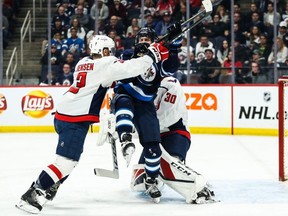 Washington Capitals' Nick Jensen checks Winnipeg Jets forward Nikolaj Ehlers in front of Washington Capitals goalie Ilya Samsonov  at Bell MTS Place. The Jets won 3-0. USA TODAY