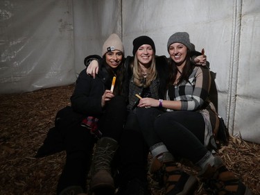 L-R: Andrea Barros, Megan Pietrus and Kayla Gagliardi share smiles while they enjoy maple syrup on snow in side the Sugar Shake at Festival du Voyageur in Winnipeg, Man., on Sunday, Feb. 16, 2020. The 51st annual Festival du Voyageur in Winnipeg, Man., runs from Feb. 14 to 23, 2020.